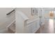 Hallway showing beautiful wall decor, neutral paint, hardwood floors, carpeted stairs, and white trim at 2208 Seneca Dr, Raleigh, NC 27604