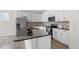 This kitchen features white cabinets, stainless steel appliances, a kitchen island, and granite countertops at 2208 Seneca Dr, Raleigh, NC 27604