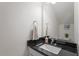 Elegant powder room featuring a modern sink, granite countertop, and decorative mirror at 2208 Seneca Dr, Raleigh, NC 27604