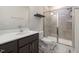 This bathroom features a tiled shower with glass doors, modern fixtures, and stylish tile flooring at 224 Daniel Ridge Rd, Wendell, NC 27591