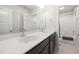 Bathroom showcasing double sinks, a large mirror, and a shower with a glass door at 224 Daniel Ridge Rd, Wendell, NC 27591