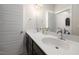 This bathroom features double sinks, modern fixtures, a large mirror and stylish tile flooring at 224 Daniel Ridge Rd, Wendell, NC 27591