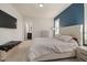 This primary bedroom features a tufted headboard, modern furnishings, and an ensuite bathroom at 224 Daniel Ridge Rd, Wendell, NC 27591