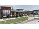 Exterior shot of Parkside Restaurant and other shops in a modern commercial district with green space at 224 Daniel Ridge Rd, Wendell, NC 27591