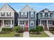 Charming blue two-story home featuring a welcoming front porch, red door, and well-maintained landscaping at 224 Daniel Ridge Rd, Wendell, NC 27591