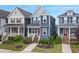 Attractive two-story blue home with a front porch, flanked by well-manicured landscaping and neighboring houses at 224 Daniel Ridge Rd, Wendell, NC 27591