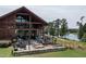 Farmhouse community building featuring lakeside patio with tables, chairs, and fountain views at 224 Daniel Ridge Rd, Wendell, NC 27591