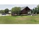Farmhouse community building with outdoor seating area, landscaped lawn, and ample parking at 224 Daniel Ridge Rd, Wendell, NC 27591