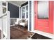 Cozy front porch featuring comfortable seating, a bright red door, and a glimpse of the home's address at 224 Daniel Ridge Rd, Wendell, NC 27591
