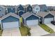 A view of neighborhood garages with driveways and tidy landscaping at 224 Daniel Ridge Rd, Wendell, NC 27591