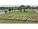 A scenic view of green space with a wooden pavilion in a community, framed by trees and manicured lawns at 224 Daniel Ridge Rd, Wendell, NC 27591