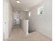 This hallway features neutral carpeting and white walls leading to other rooms and stairs at 224 Daniel Ridge Rd, Wendell, NC 27591