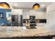 Contemporary kitchen featuring stainless steel appliances, a large island with a granite countertop, and modern pendant lighting at 224 Daniel Ridge Rd, Wendell, NC 27591