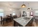 Open-concept kitchen and dining area featuring a large island with granite countertops and modern lighting fixtures at 224 Daniel Ridge Rd, Wendell, NC 27591