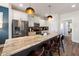 Modern kitchen with stainless steel appliances, white cabinets, and a large island with granite countertops and barstool seating at 224 Daniel Ridge Rd, Wendell, NC 27591