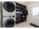 Laundry room equipped with washer, dryer, built-in shelving, and an exterior door at 224 Daniel Ridge Rd, Wendell, NC 27591