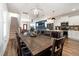 Spacious open floor plan with a dining table, modern kitchen, and staircase access to upper floors at 224 Daniel Ridge Rd, Wendell, NC 27591