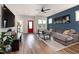 Stylish living room with hardwood floors, a comfortable gray couch, and a striking accent wall at 224 Daniel Ridge Rd, Wendell, NC 27591