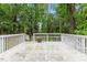 Backyard deck with a painted surface overlooking mature trees and landscaping at 2324 Stevens Rd, Raleigh, NC 27610
