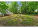 Picture of a vast backyard highlighting the open space, seating, deck, and natural surroundings at 2324 Stevens Rd, Raleigh, NC 27610