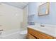 Clean bathroom featuring a tub and shower, a vanity and a wooden mirror at 2324 Stevens Rd, Raleigh, NC 27610