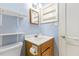 Well-lit bathroom with a single sink vanity, mirror and toilet at 2324 Stevens Rd, Raleigh, NC 27610