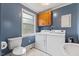 Laundry area featuring a washer, dryer, and utility sink at 2324 Stevens Rd, Raleigh, NC 27610