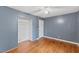 Bedroom with closet, hardwood floors, ceiling fan and neutral paint at 2324 Stevens Rd, Raleigh, NC 27610
