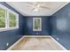 Bedroom featuring neutral carpet, two windows for ample natural light, and a ceiling fan at 2324 Stevens Rd, Raleigh, NC 27610