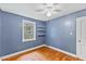 Bedroom featuring hardwood floors, natural light, and custom shelving at 2324 Stevens Rd, Raleigh, NC 27610