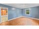 Bright bedroom with hardwood floors, blue walls and an open layout at 2324 Stevens Rd, Raleigh, NC 27610