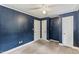 Bedroom featuring blue accent walls, tan carpeting, two closets and white trim at 2324 Stevens Rd, Raleigh, NC 27610