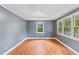 Bright bedroom featuring hardwood floors, large windows, and neutral paint at 2324 Stevens Rd, Raleigh, NC 27610