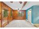 Inviting living room with carpet floors, wood walls, and natural light at 2324 Stevens Rd, Raleigh, NC 27610
