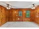 A cozy living room featuring wood walls, and natural light at 2324 Stevens Rd, Raleigh, NC 27610