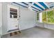 Screened porch with painted blue ceiling, white trim, and access to the backyard at 2324 Stevens Rd, Raleigh, NC 27610