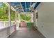 Screened porch featuring a painted blue ceiling, ample light and colorful trim accent at 2324 Stevens Rd, Raleigh, NC 27610