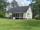 Spacious backyard with a screened-in porch, ideal for outdoor relaxation and entertainment at 2436 Nc 97, Zebulon, NC 27597