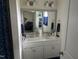 Bright bathroom features a double vanity with framed mirror and decorative lighting at 2436 Nc 97, Zebulon, NC 27597