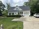 Charming two-story home featuring a well-maintained lawn and attached two car garage at 2436 Nc 97, Zebulon, NC 27597