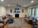 Cozy living room featuring hardwood floors, a fireplace, and comfortable seating at 2436 Nc 97, Zebulon, NC 27597