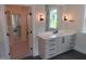 Bathroom vanity with drawers, cabinets, and a mirror with sconces and a view into the water closet at 2577 Silas Peak Ln, Apex, NC 27523