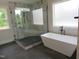 New bathroom featuring glass shower, freestanding tub, and modern fixtures in a well-lit space at 2577 Silas Peak Ln, Apex, NC 27523