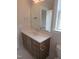 Bathroom vanity boasts white countertop, wood cabinetry, chrome hardware, and modern mirror at 2577 Silas Peak Ln, Apex, NC 27523
