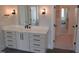 Bathroom vanity with drawers, cabinets, and a mirror with a view into the water closet at 2577 Silas Peak Ln, Apex, NC 27523
