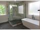 New bathroom featuring glass shower, freestanding tub, and modern fixtures in a well-lit space at 2577 Silas Peak Ln, Apex, NC 27523