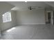 Spacious bedroom featuring a ceiling fan, natural light, neutral walls, and an open doorway at 2577 Silas Peak Ln, Apex, NC 27523