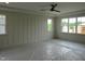 The light-filled bedroom has bright trim and a board and batten accent wall at 2577 Silas Peak Ln, Apex, NC 27523