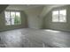 Spacious bedroom with bright natural light from two windows, neutral walls, and a clean, modern aesthetic at 2577 Silas Peak Ln, Apex, NC 27523