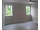 Bright bedroom with two windows and ceiling fan, prepped for new floors at 2577 Silas Peak Ln, Apex, NC 27523